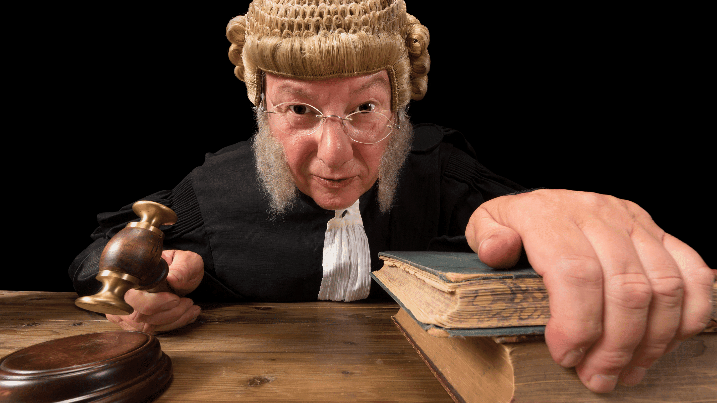 A judge in a wig and glasses holding a gavel, presiding over a court case related to an auto accident.