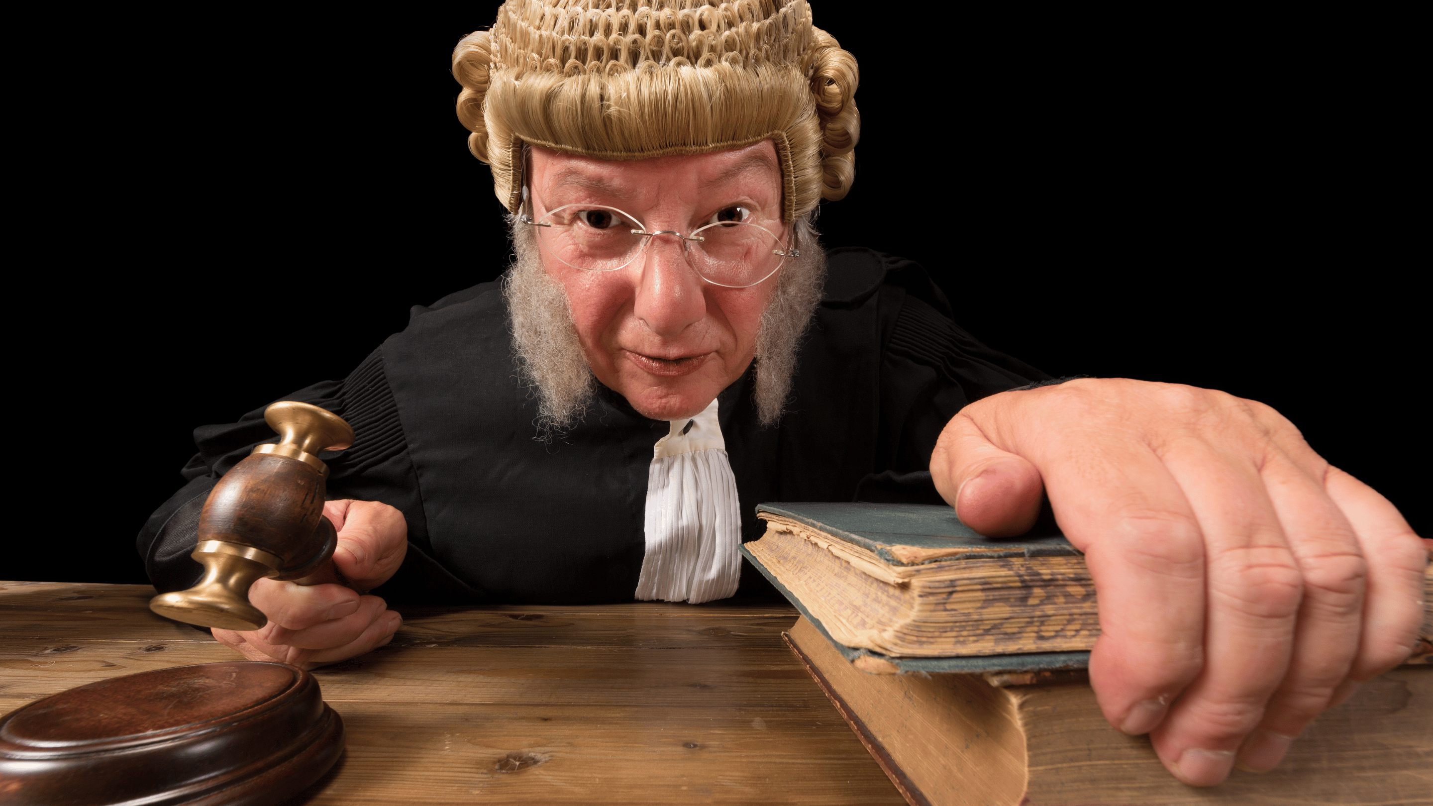 A judge in a wig and glasses holding a gavel, presiding over a court case related to an auto accident.