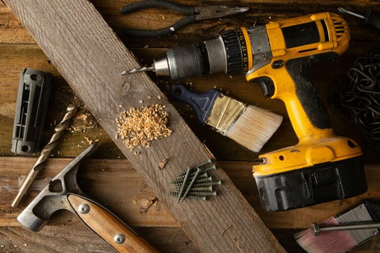 Power drill and woodworking tools on a workbench, representing a defective power tool injury and potential product liability claim in Nevada.